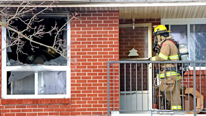 Petrolia firefighters work inside the Greenfield St. apartment which was destroyed by fire Sunday afternoon.